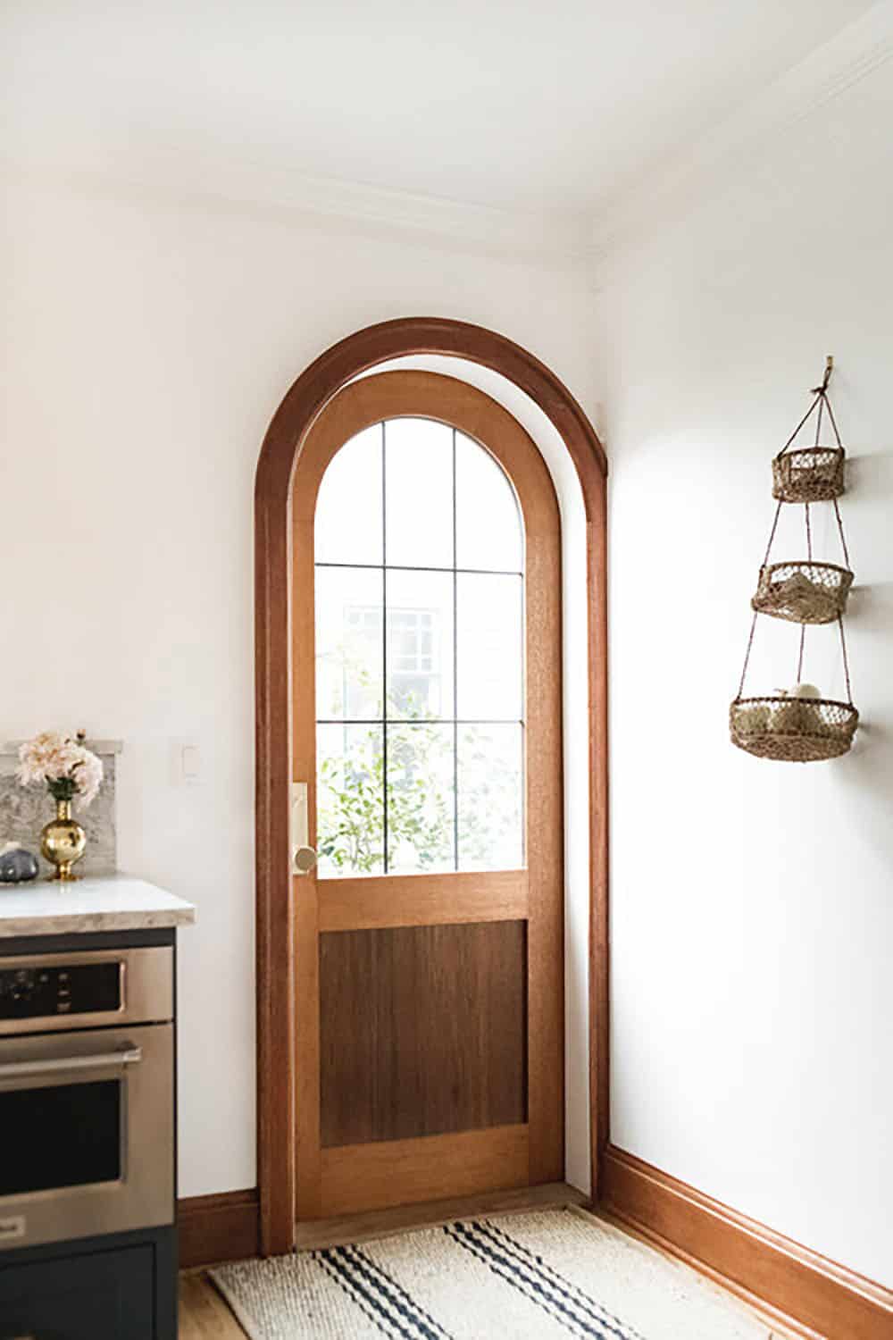 transitional stye kitchen with an arched door