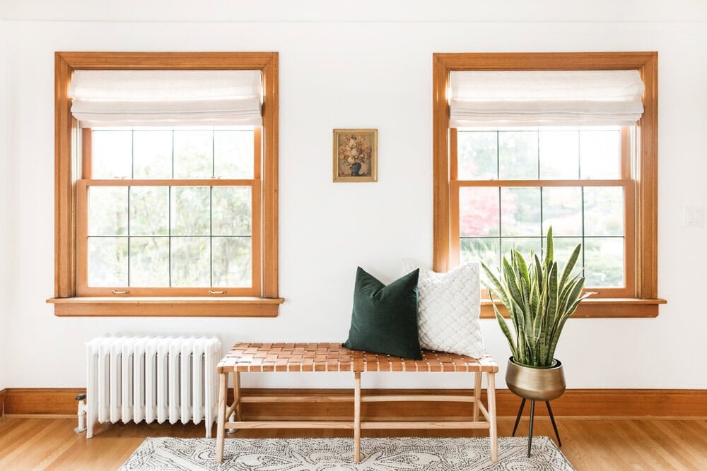 transitional stye living room with a bench and two windows