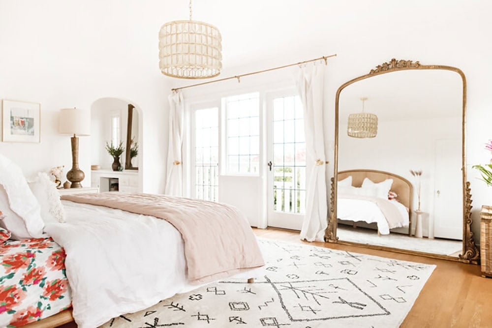 transitional stye bedroom with a large floor mirror