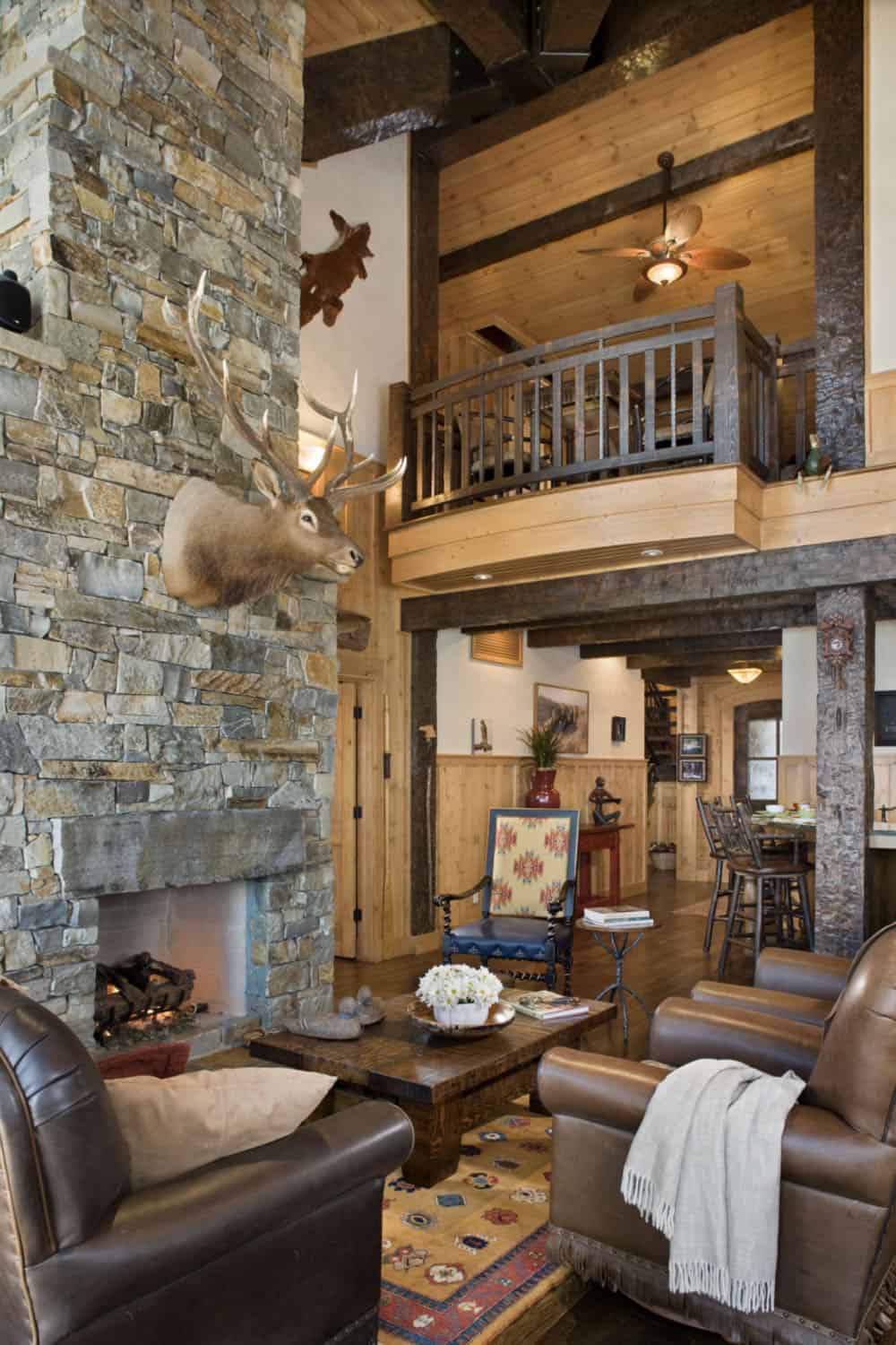 rustic living room with a stone fireplace