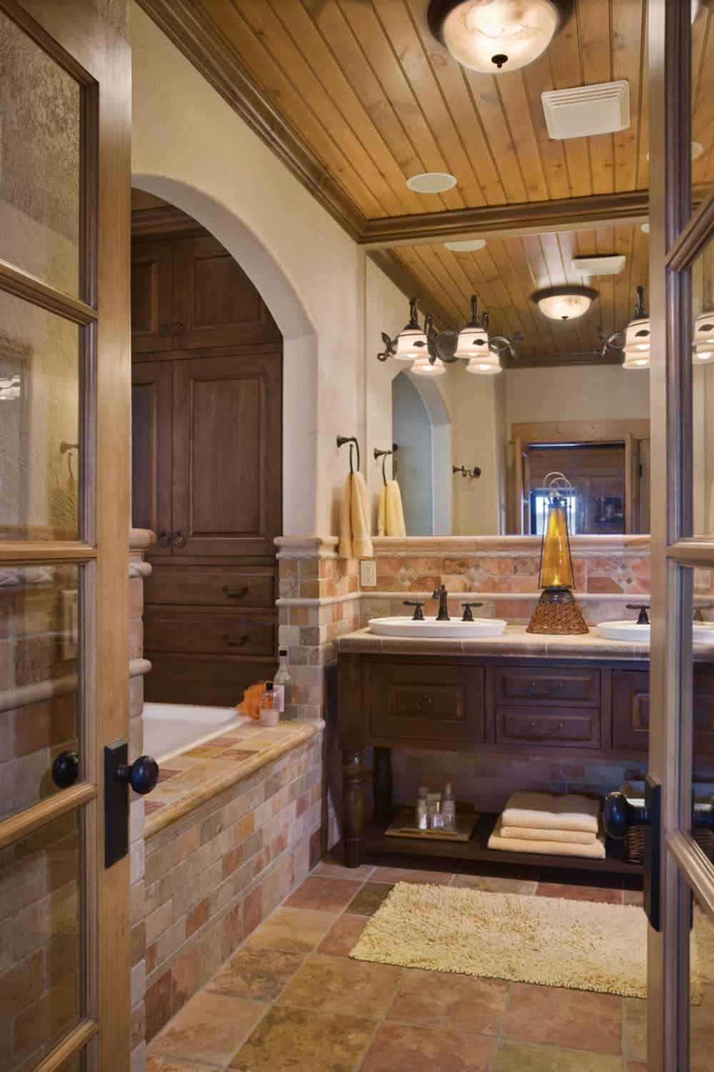 rustic bathroom with an integrated tub and vanity