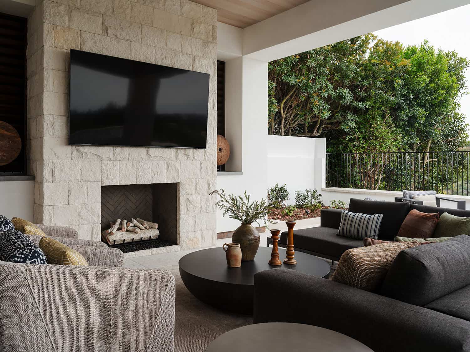 contemporary covered patio with outdoor furniture and a fireplace