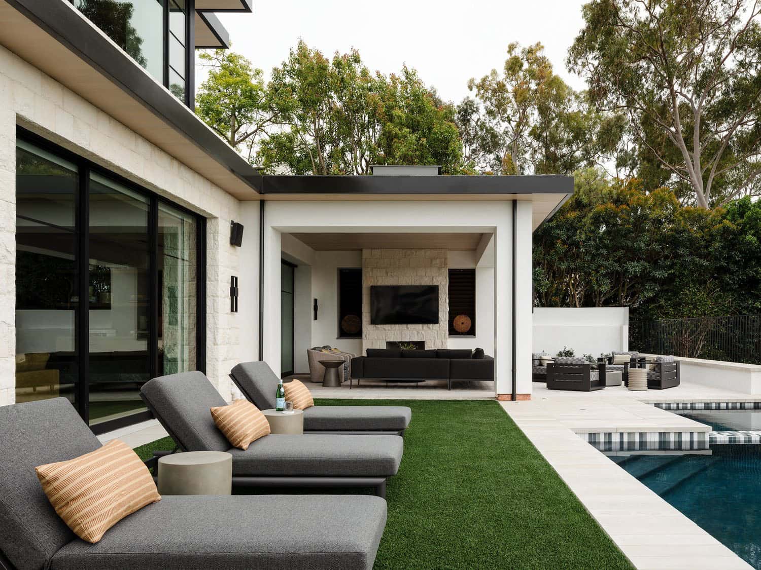 contemporary home exterior backyard with chaise lounges