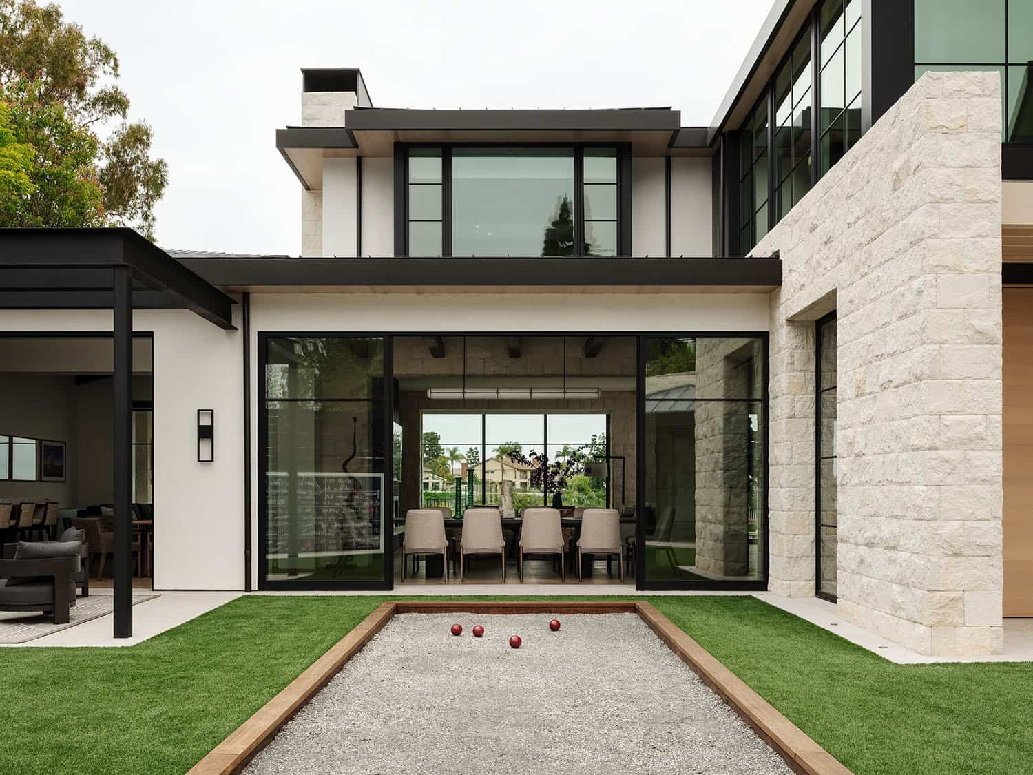 contemporary home exterior with a bocce ball court