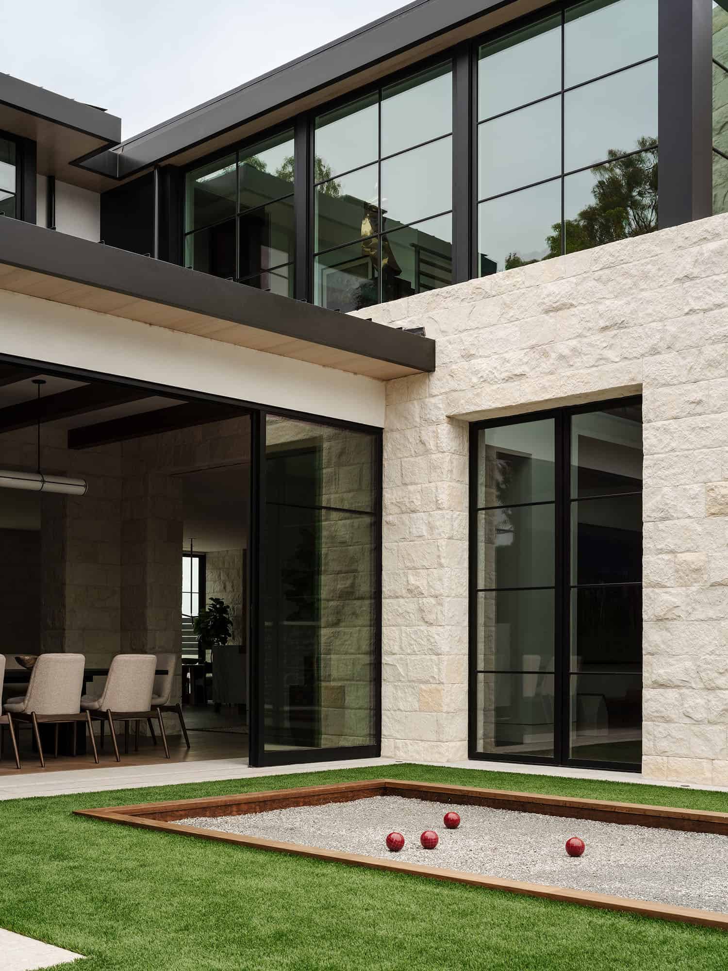 contemporary home exterior with a bocce ball court