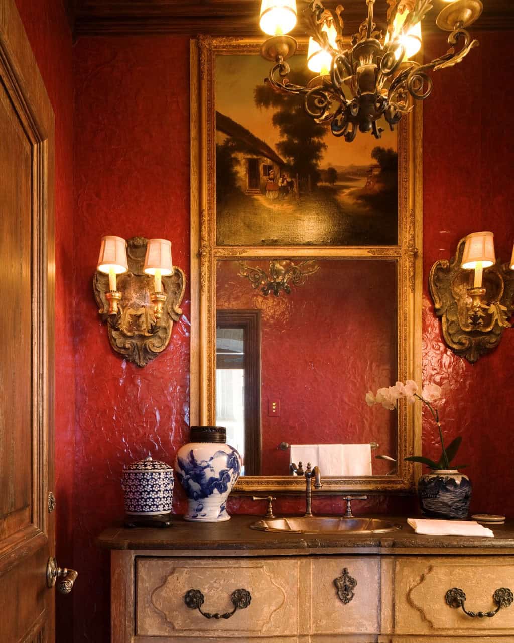 mediterranean style powder room with red walls