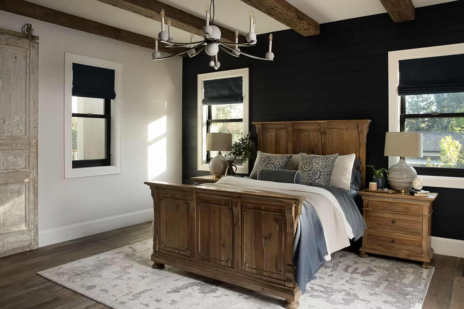farmhouse style bedroom with a black accent wall