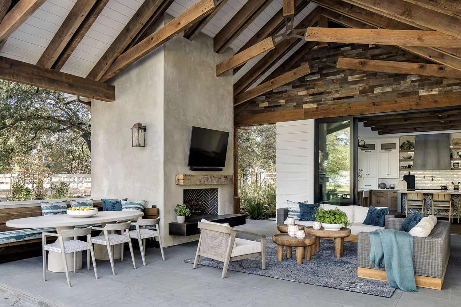 farmhouse style covered patio with a fireplace and outdoor furniture