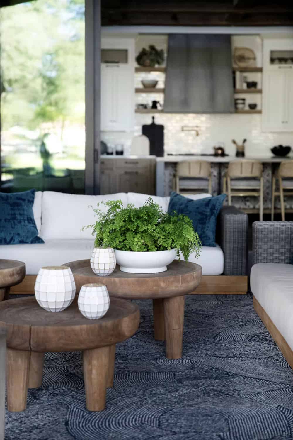 farmhouse style covered outdoor kitchen with furniture