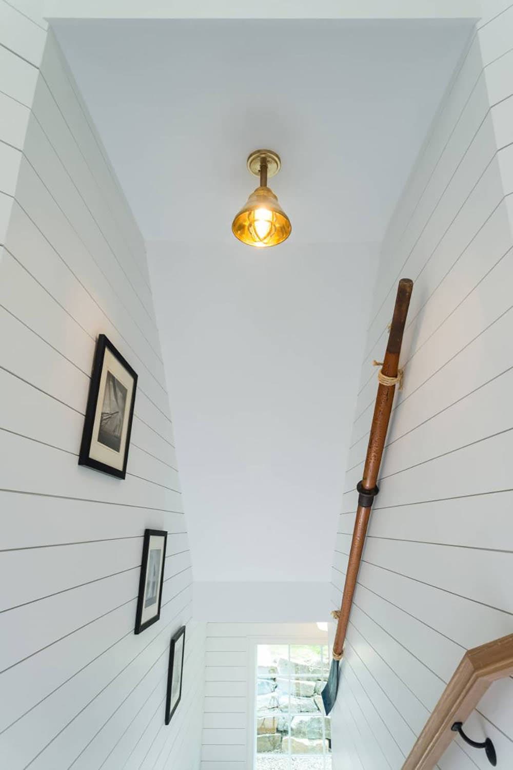 contemporary staircase with shiplap walls