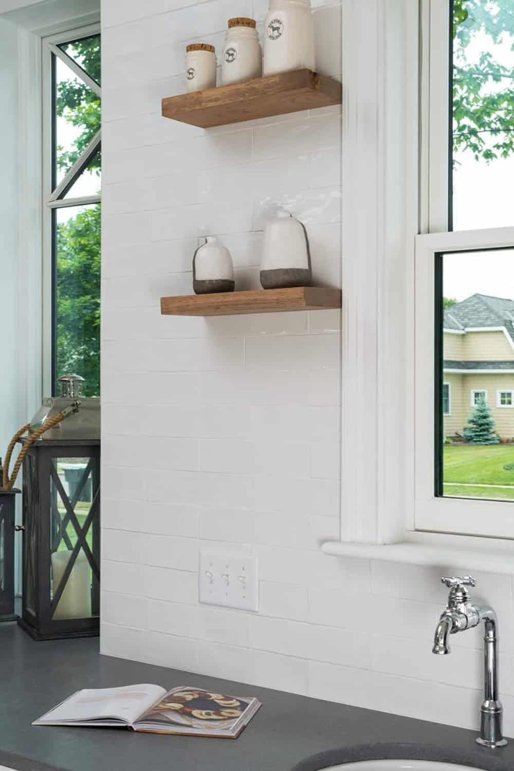 contemporary kitchen with sink and floating shelves