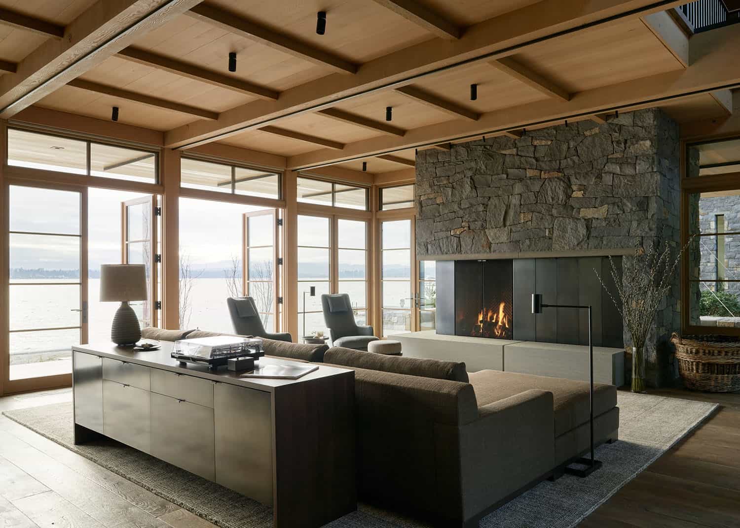 modern living room with a fireplace and floor-to-ceiling glass