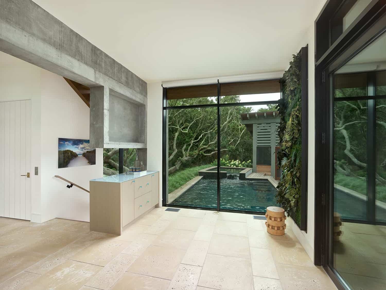 modern hallway with a glass wall and view of the swimming pool