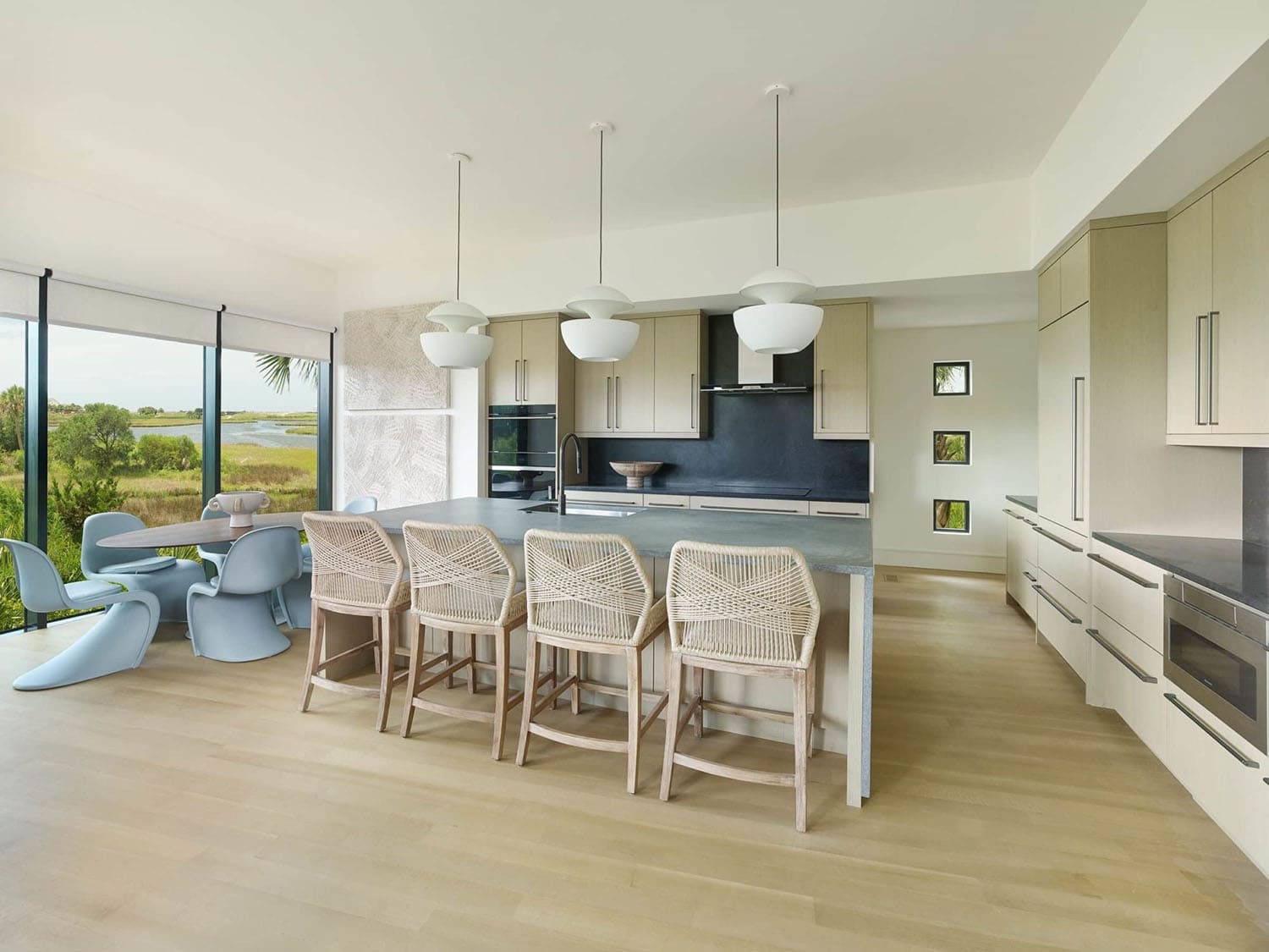 modern kitchen and dining nook with a large window