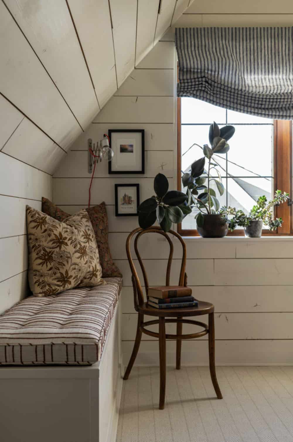 contemporary bedroom with built-in bench and sloped ceiling