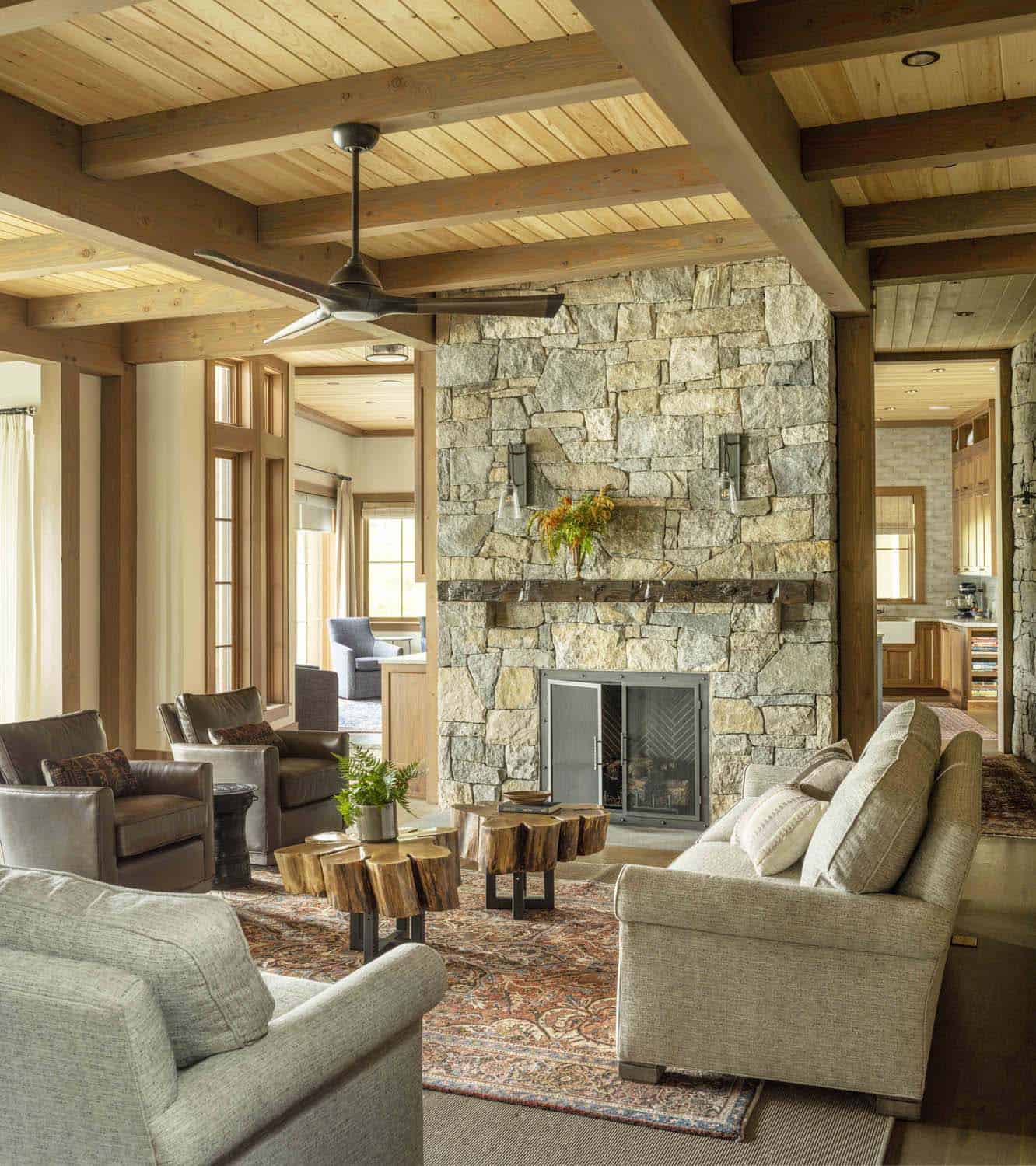 rustic living room with a stone fireplace