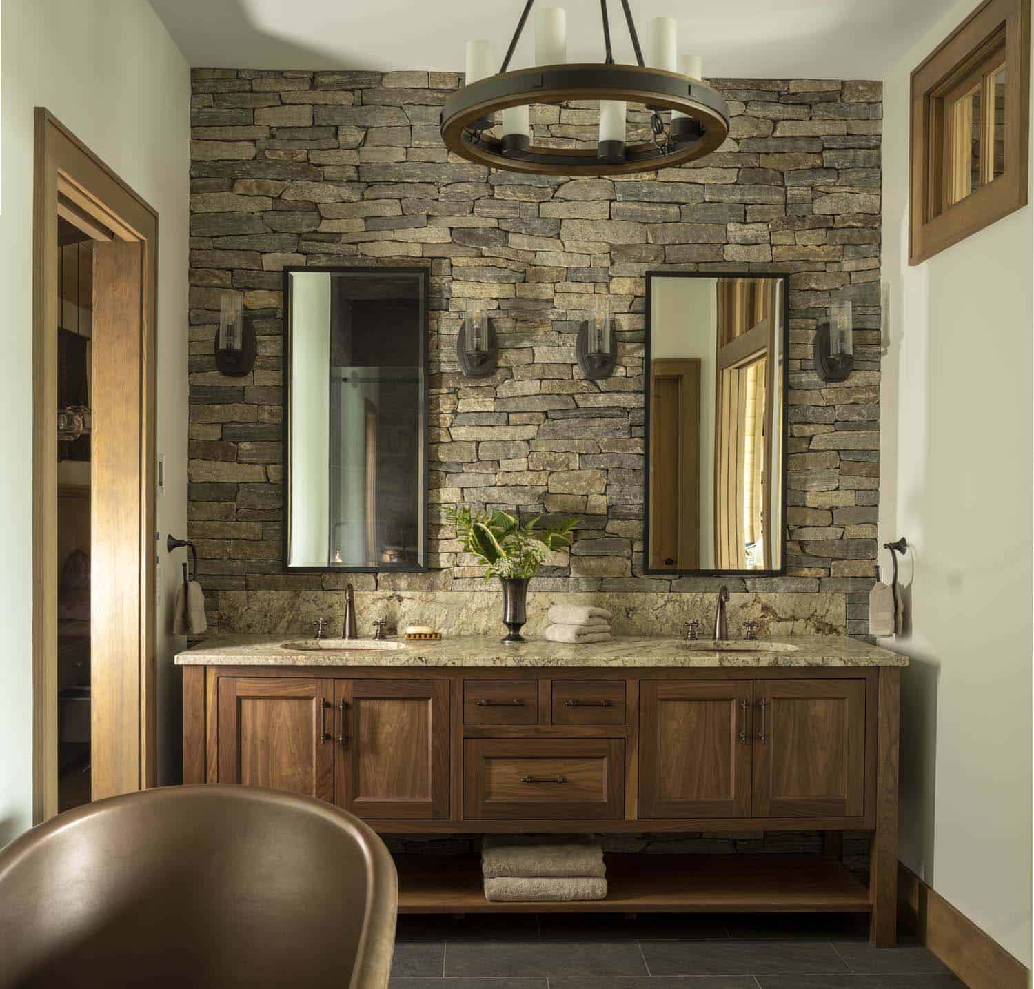 rustic bathroom with dual sinks and mirrors