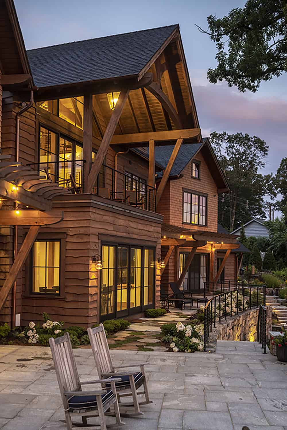 rustic house exterior with a patio at dusk