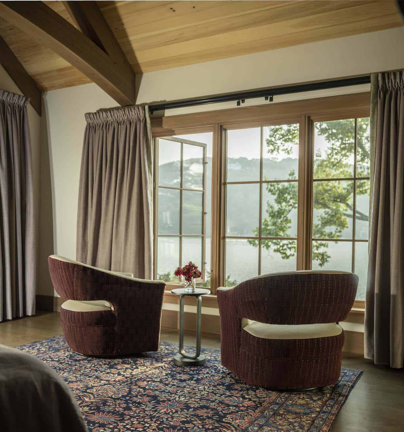 rustic bedroom with a sitting area in front of a window