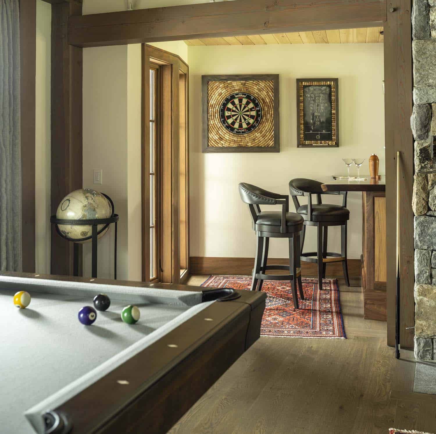 rustic family room with a dart board and home bar