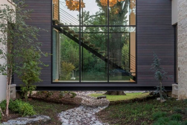 featured posts image for This striking Dallas home features a glass bridge over a serene landscape