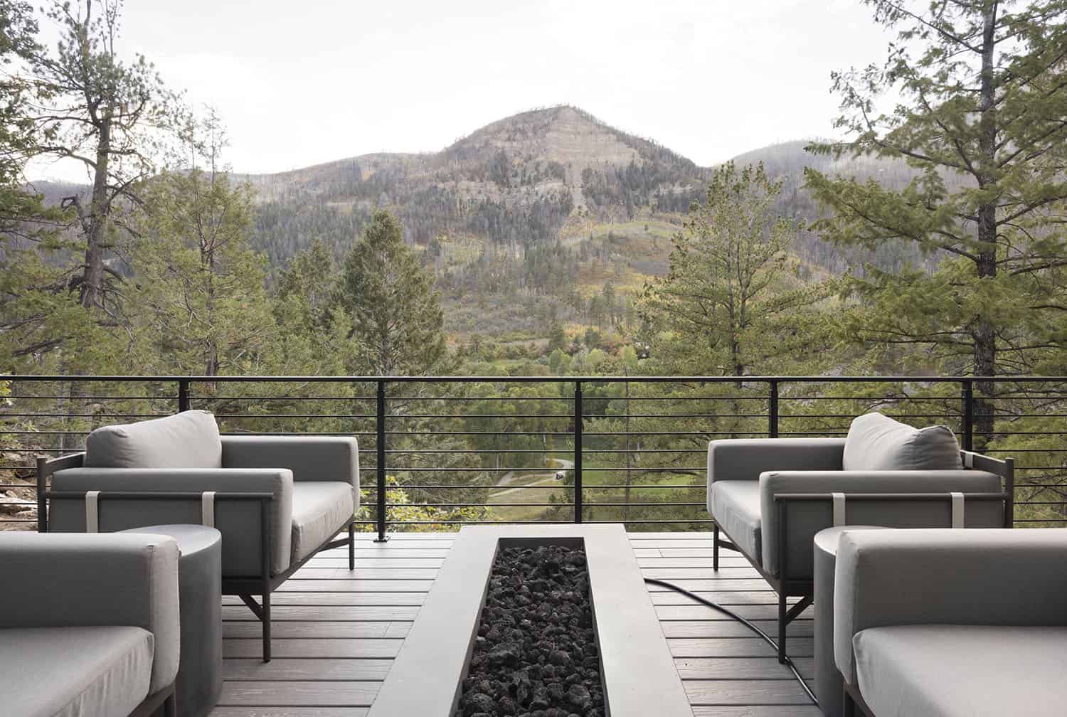modern rustic mountain home patio with outdoor furniture and a fire pit
