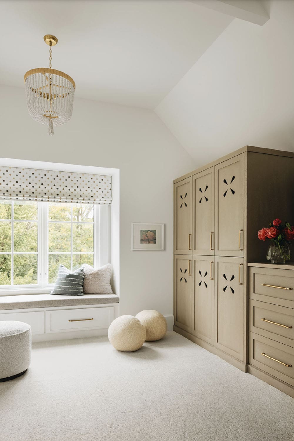 transitional bedroom with built-in closet storage and a window seat