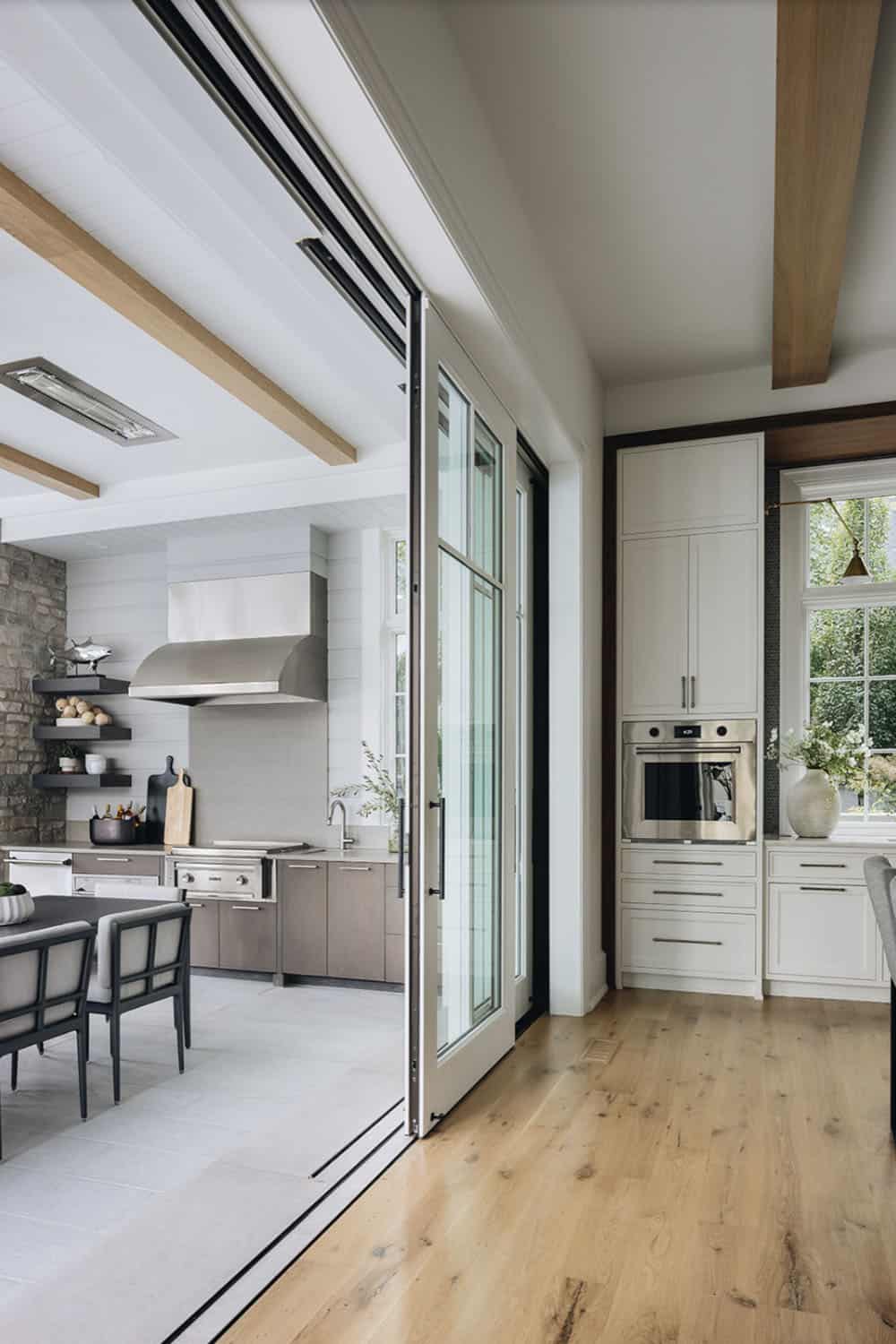 transitional kitchen with sliding glass doors connecting to a backyard patio with a grill