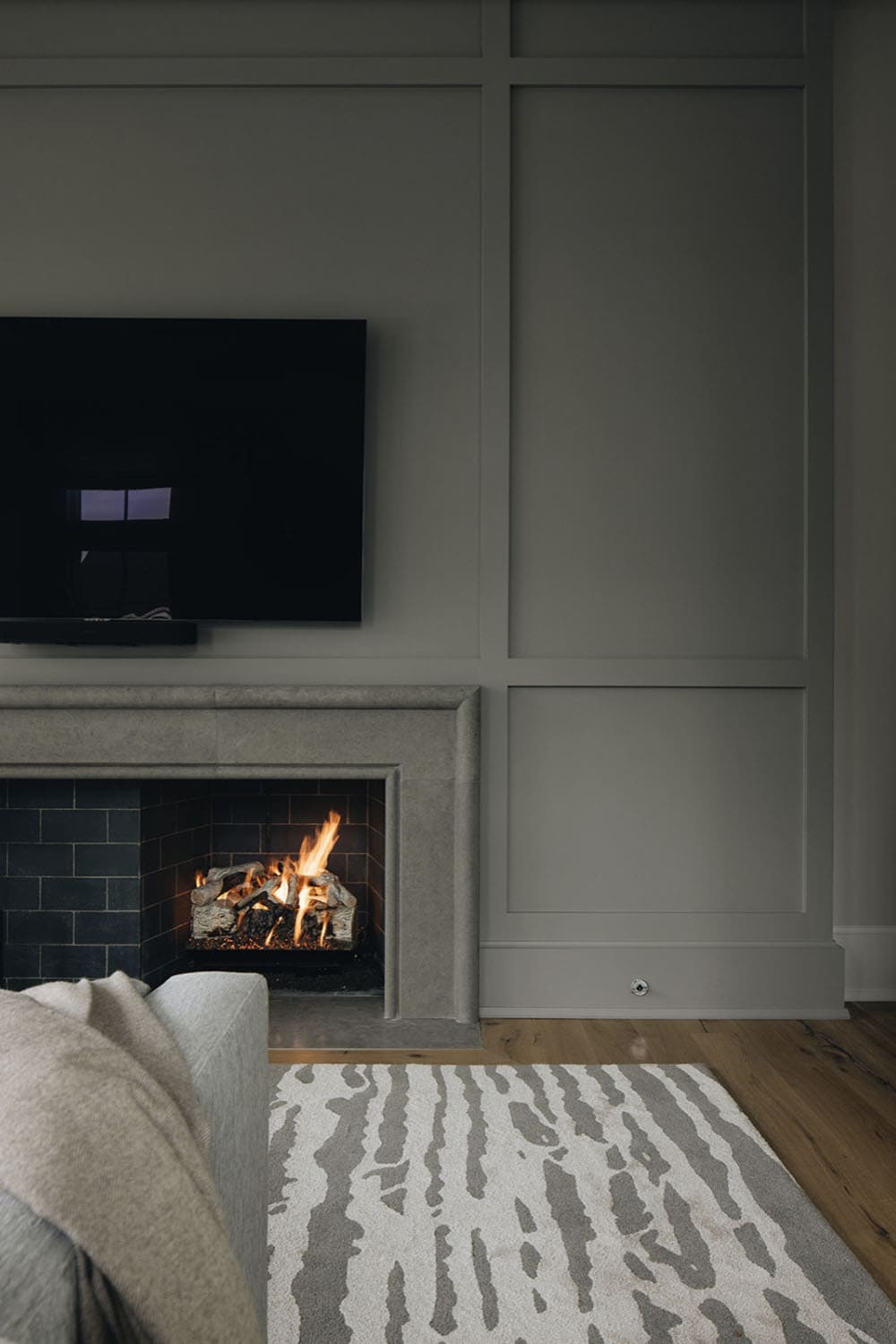 transitional family room tv wall with a fireplace