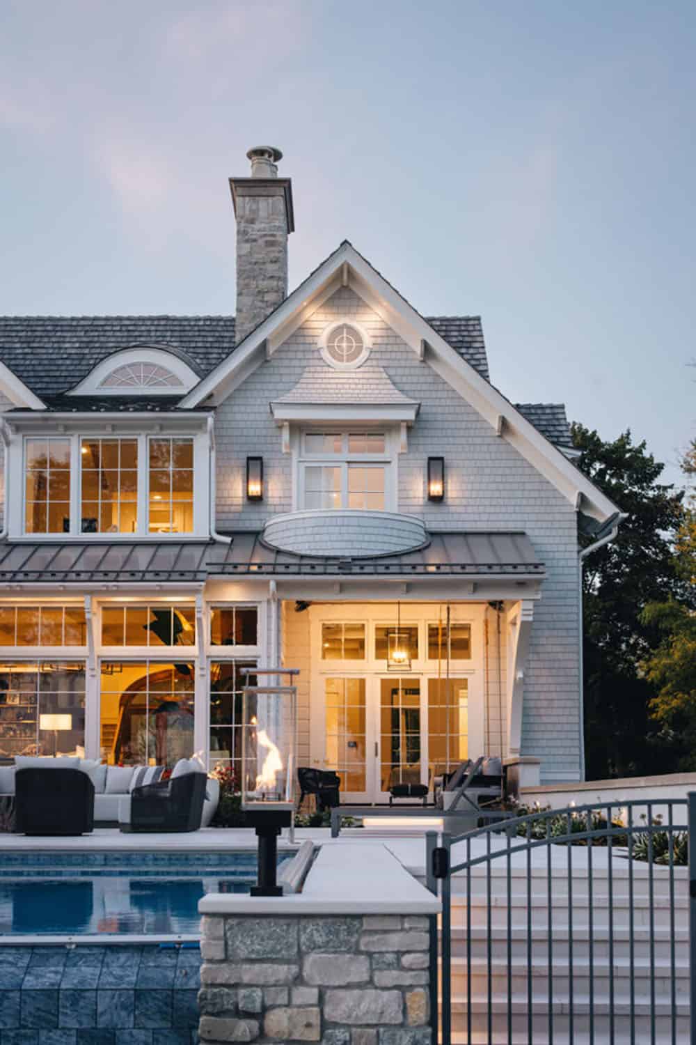 transitional home exterior with a pool
