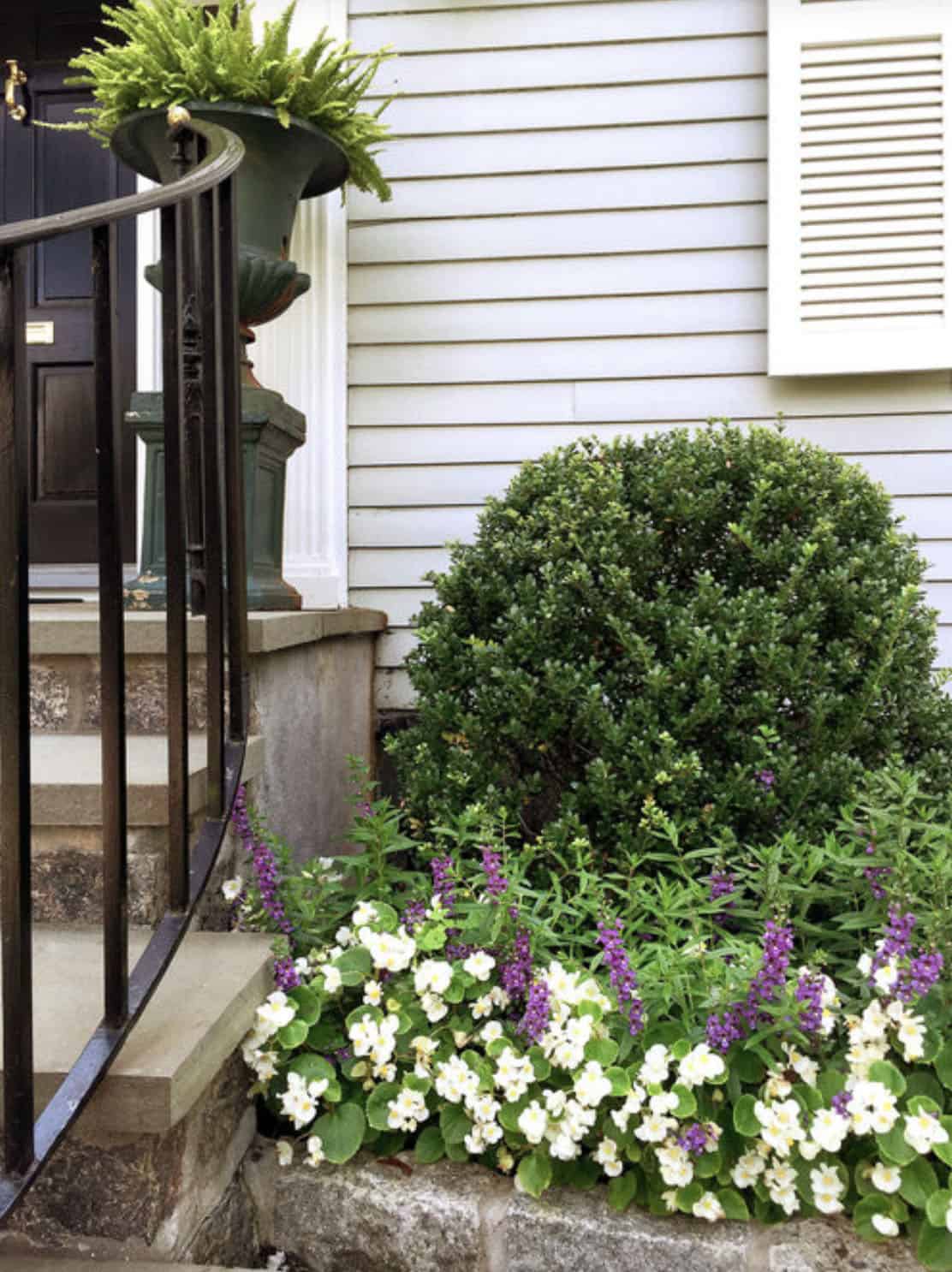 small flower bed at the front entry of a home