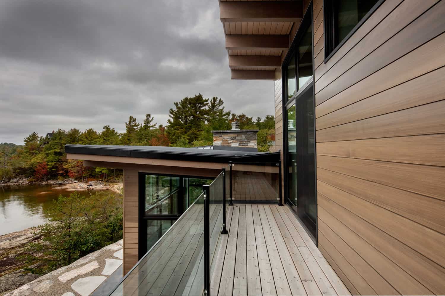 contemporary lakefront cottage exterior with a balcony
