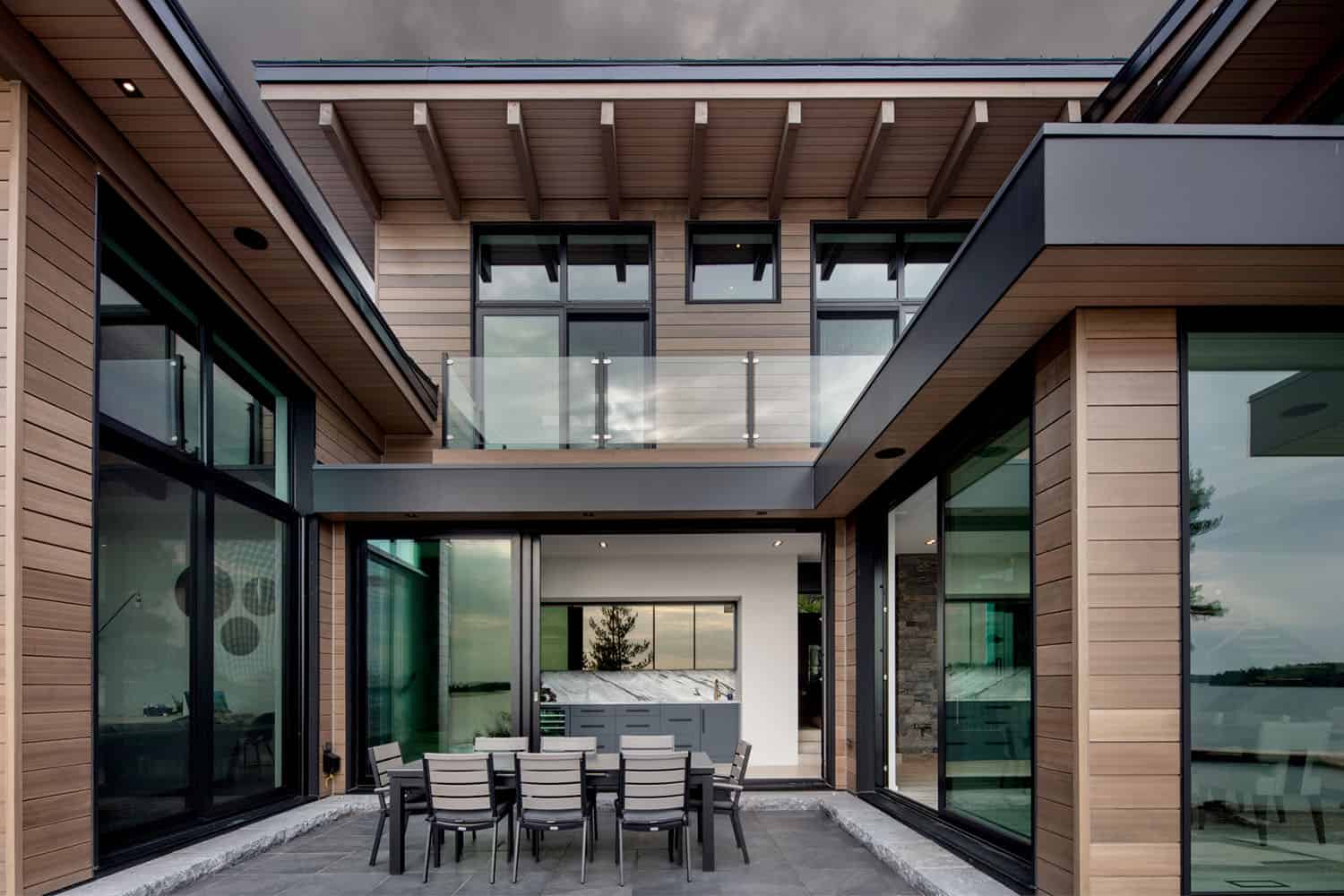 contemporary lakefront cottage exterior with alfresco dining