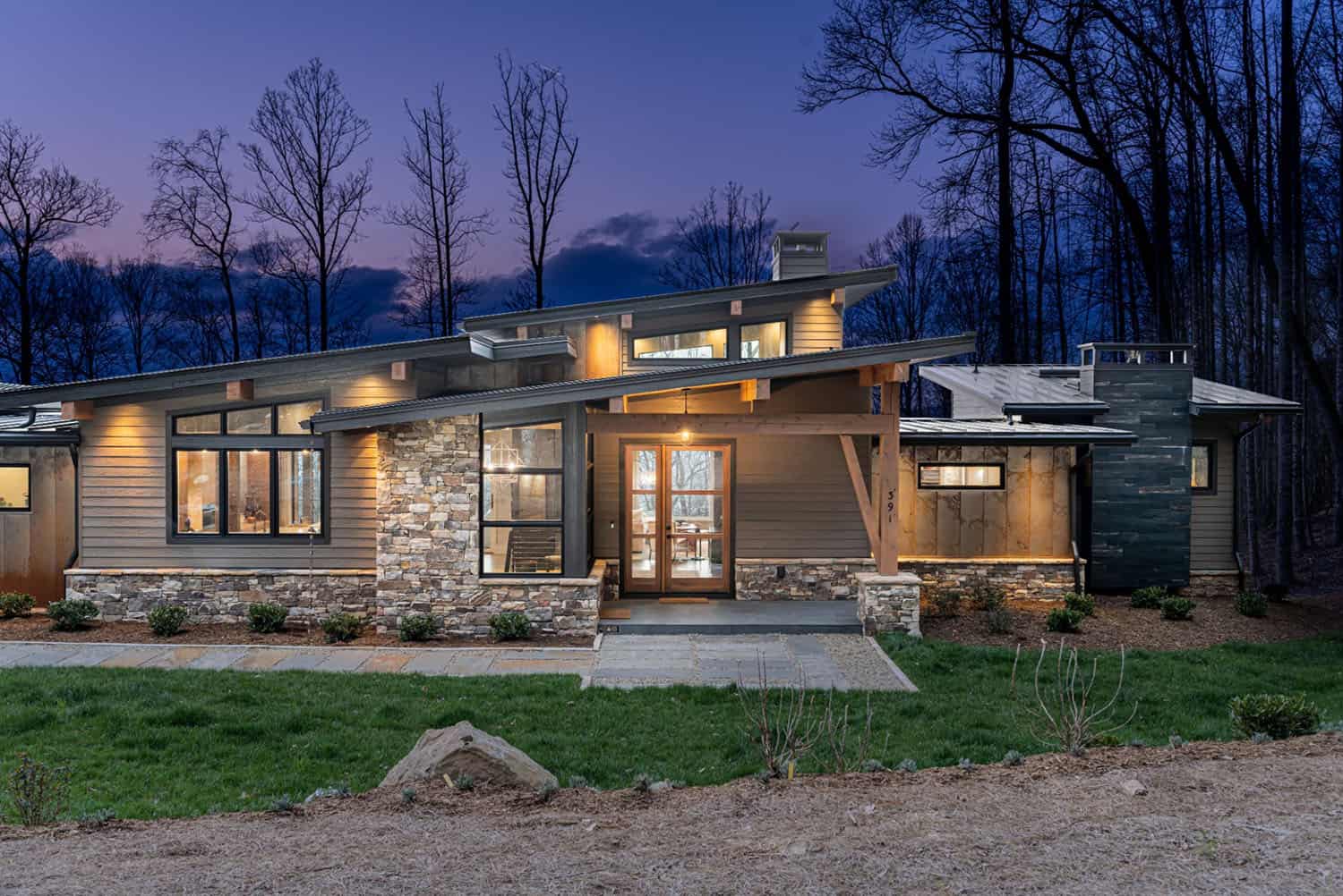 contemporary mountain home exterior at dusk