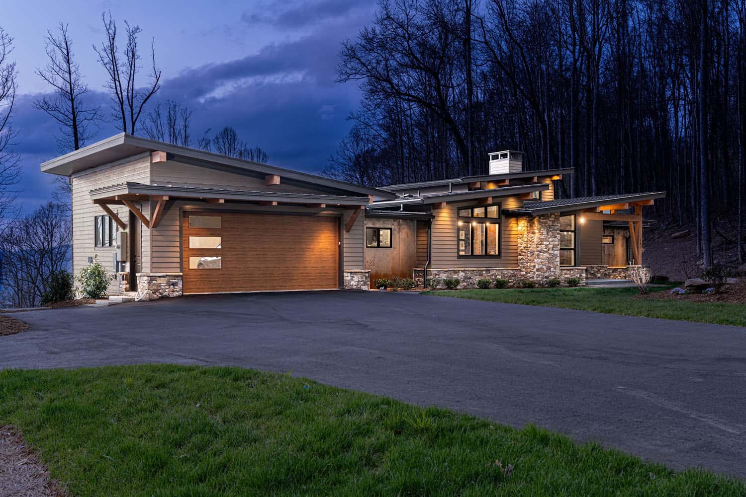 contemporary mountain home exterior at dusk
