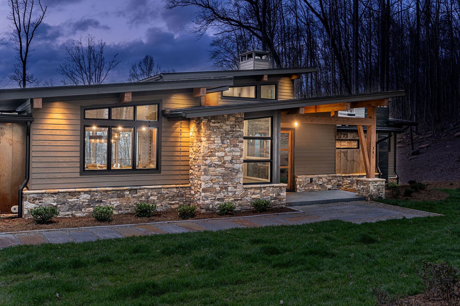 contemporary mountain home exterior at dusk