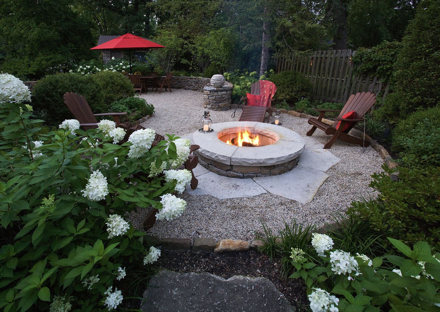 fire pit with gravel and garden beds