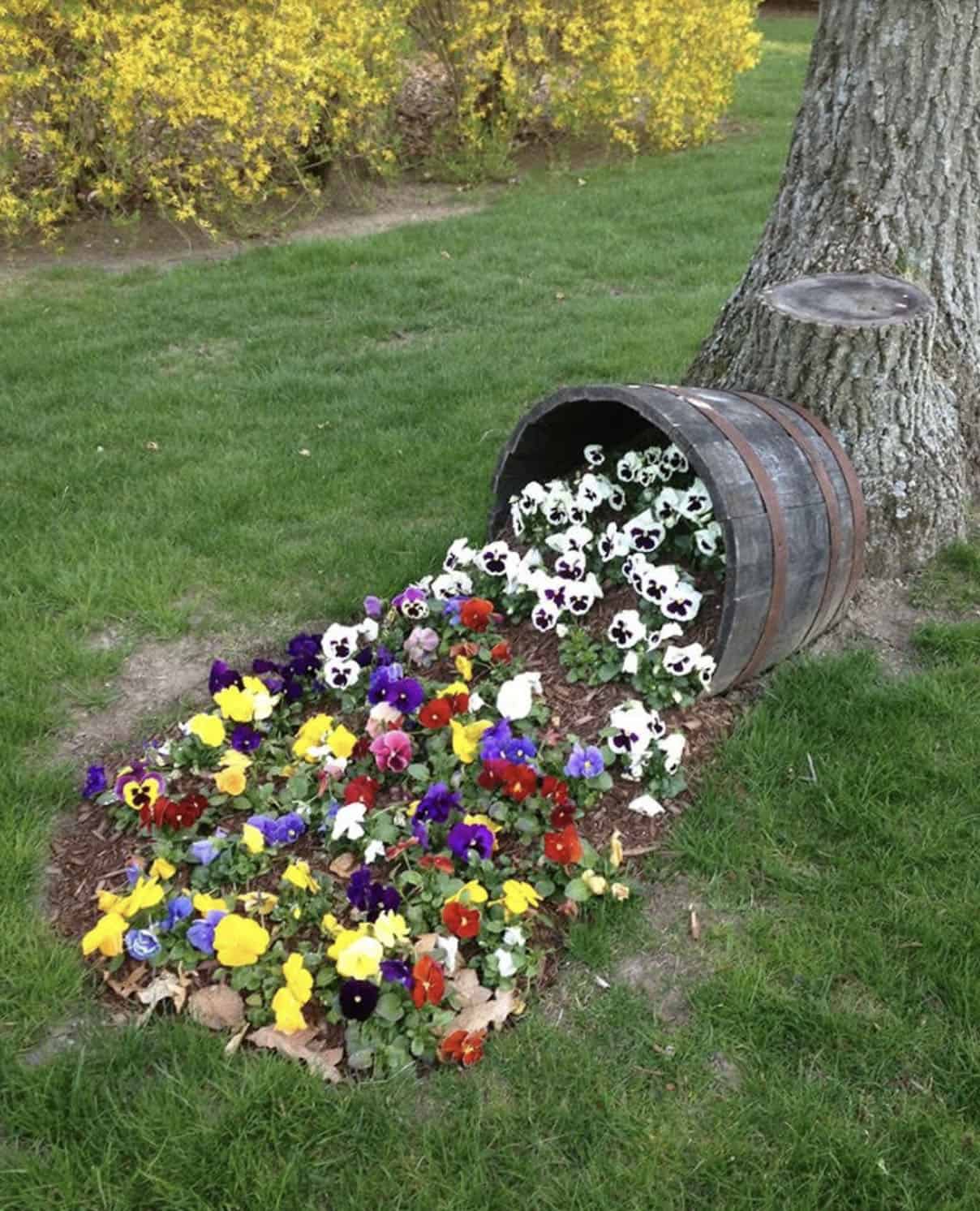 resin whiskey barrel with spilled flowers