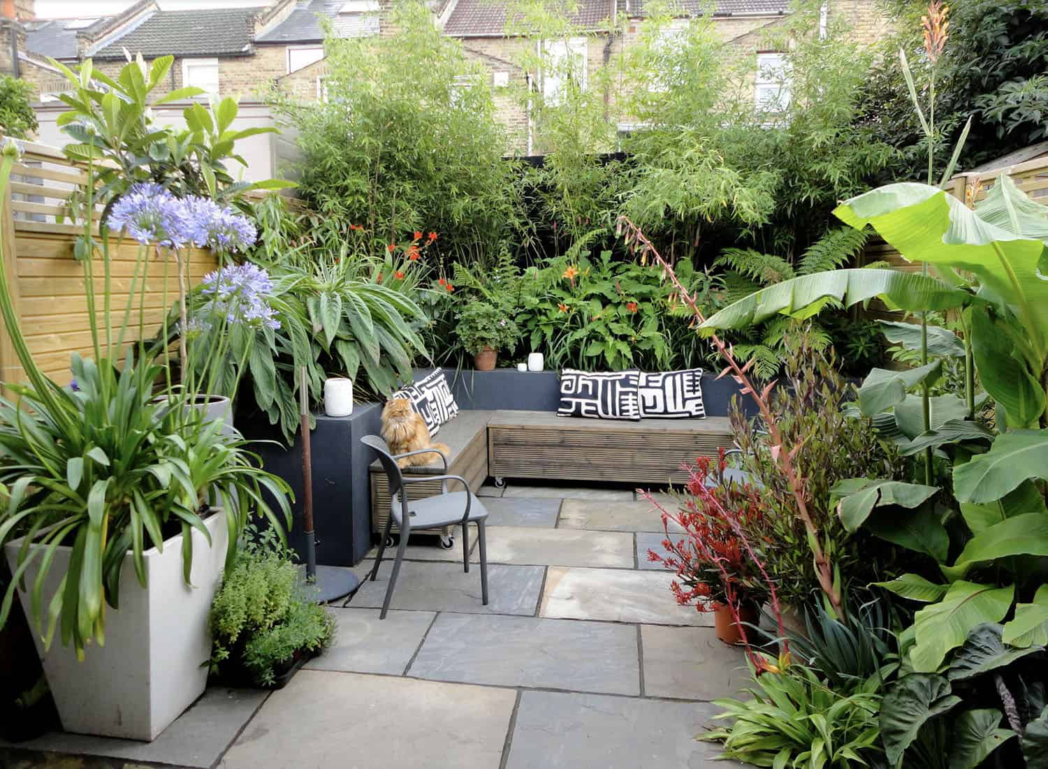small urban backyard with a garden and built-in seating