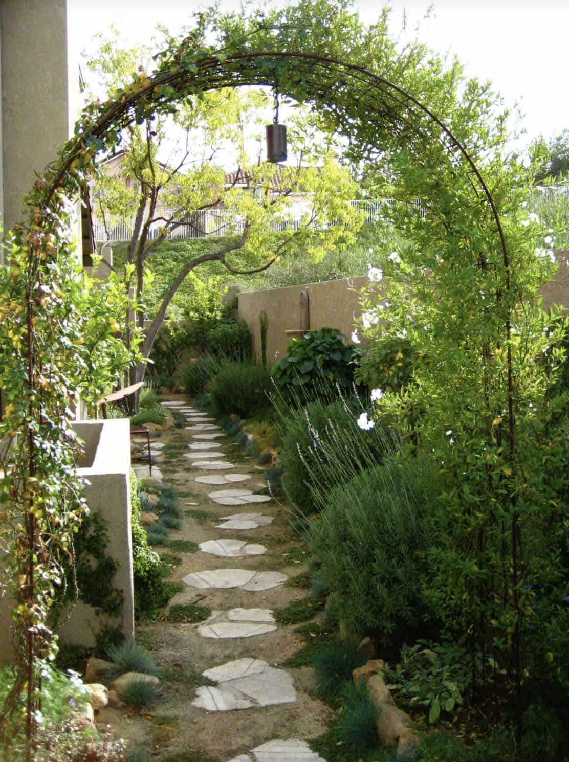 front entry garden pathway with an arbor