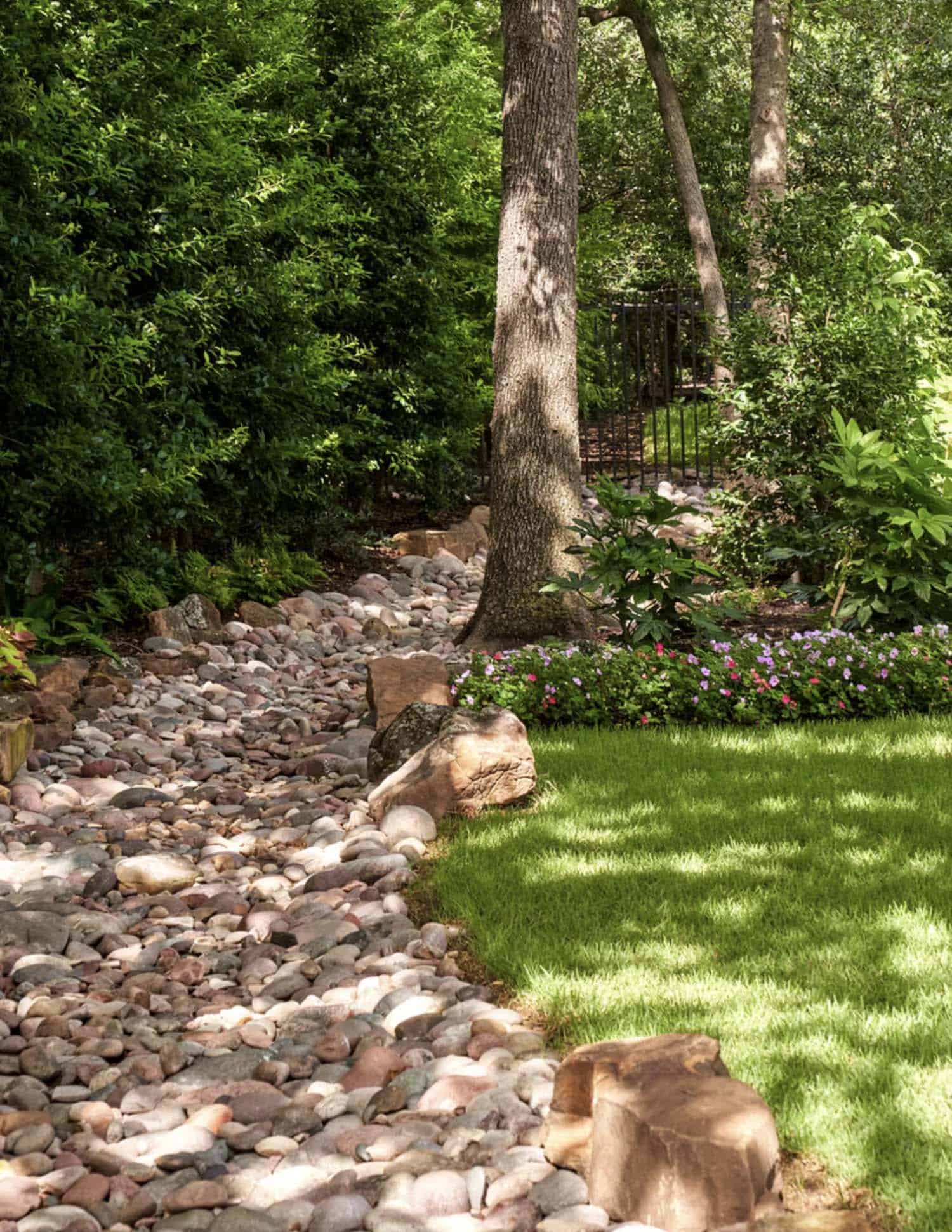 contemporary home exterior landscape with a dry river bed