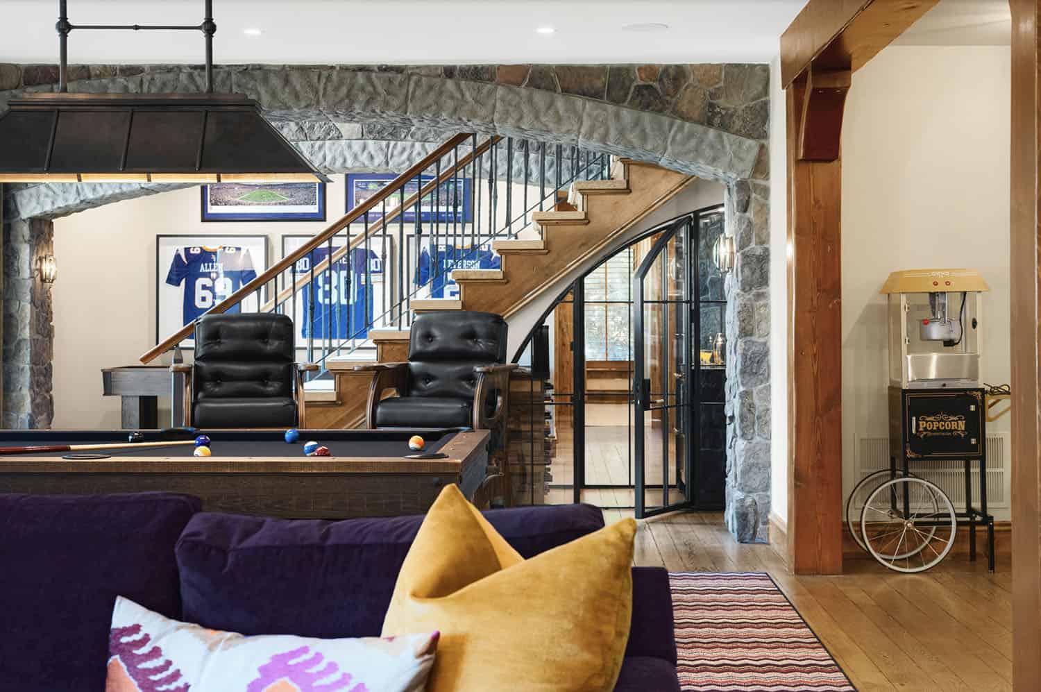 rustic gaming room with a wine cellar under the staircase 