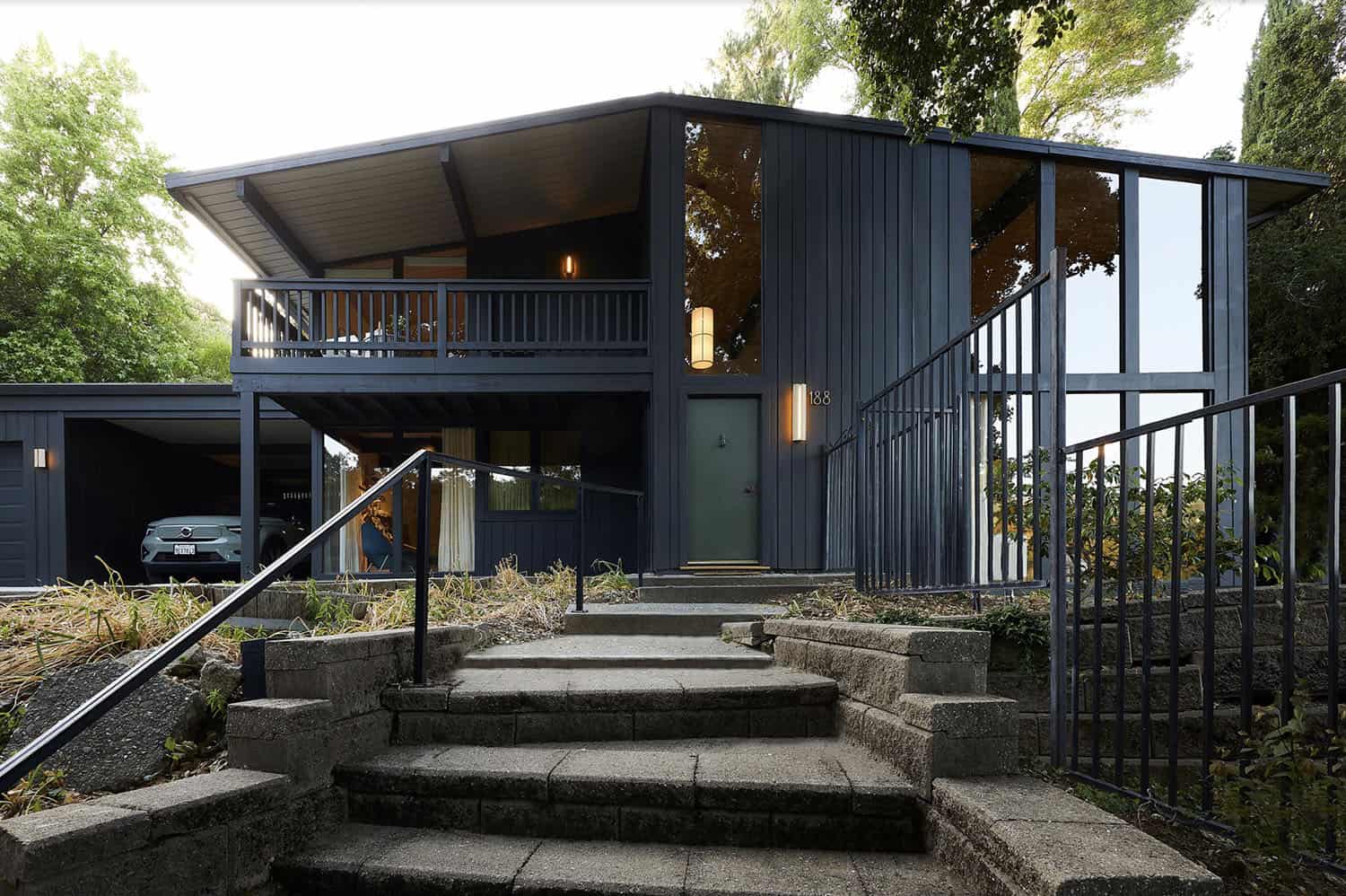 A midcentury modern home with steps leading up to it