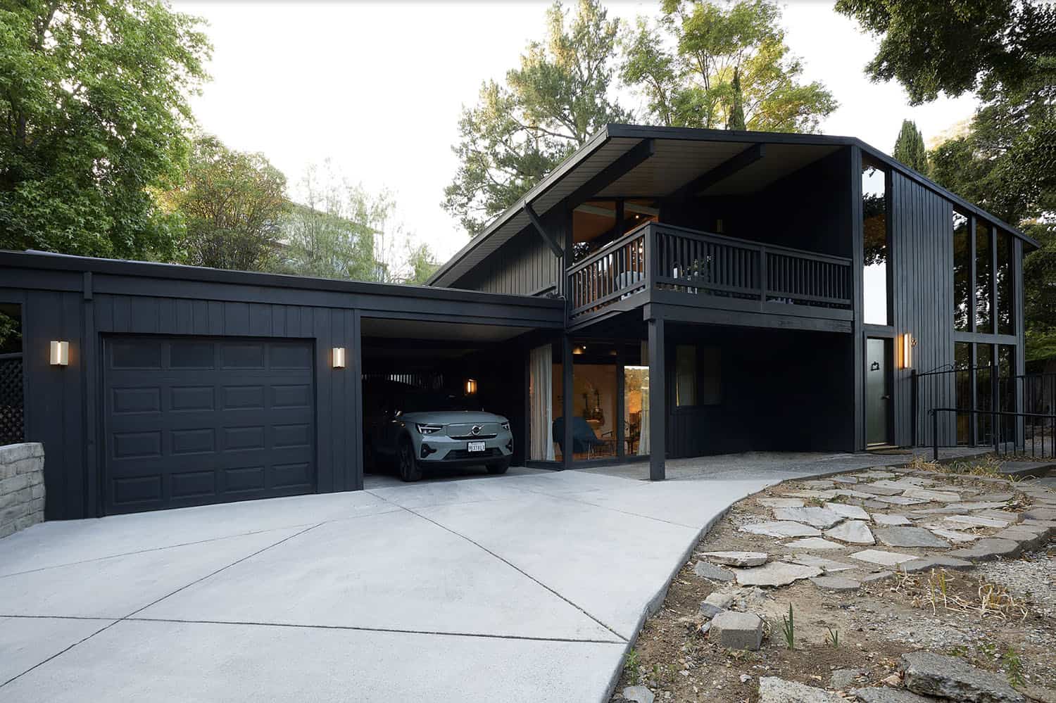 A midencenturymodern home with a garage and driveway