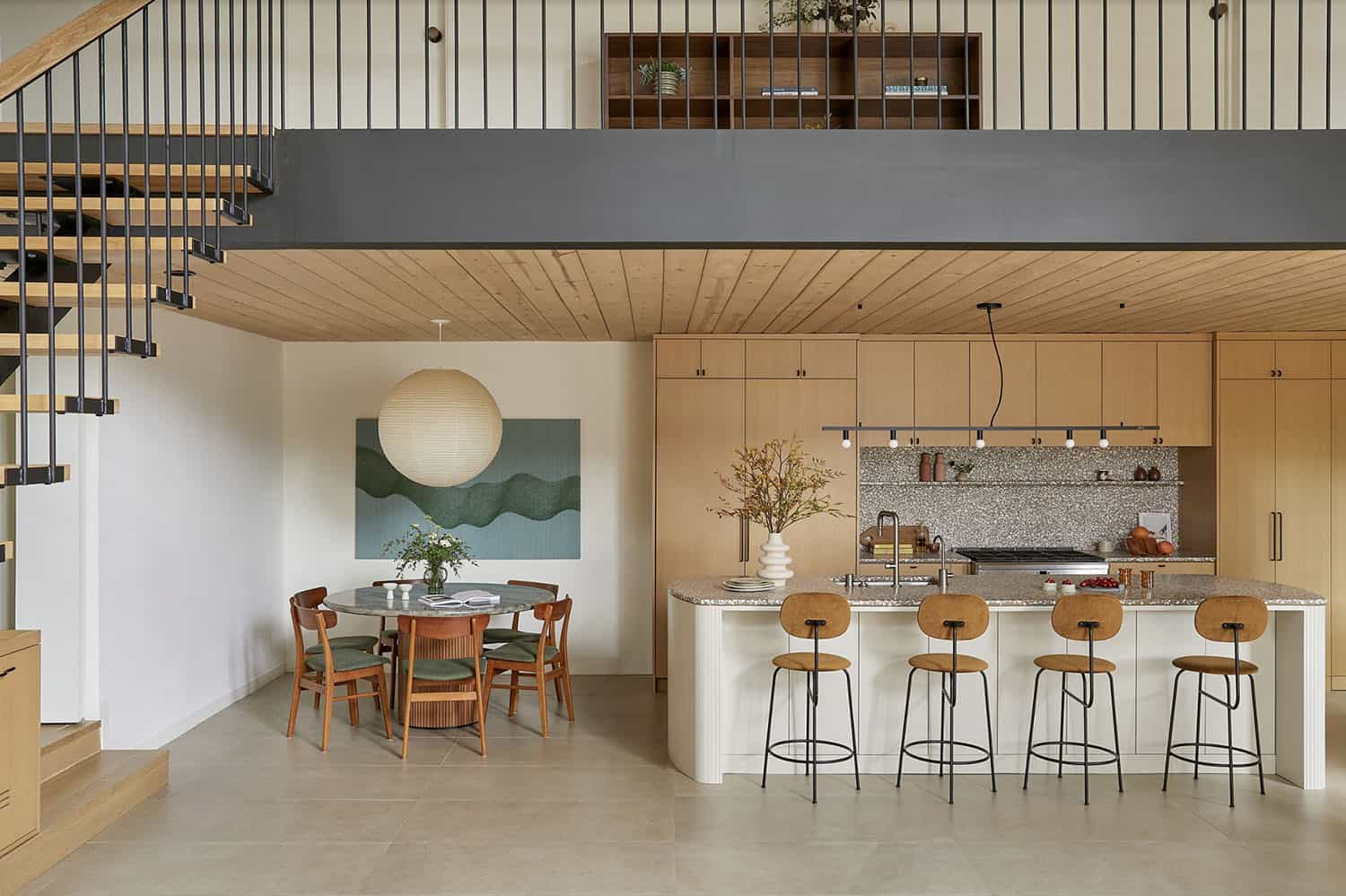 A kitchen and dining area with stairs