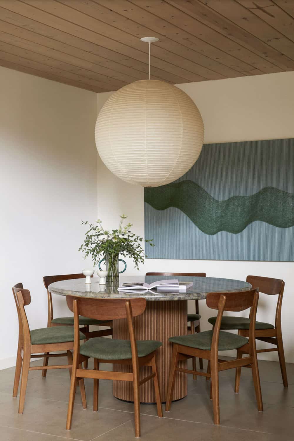 A kitchen with wooden ceiling and stools