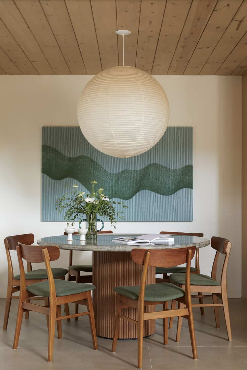 A kitchen with wooden ceiling and stools