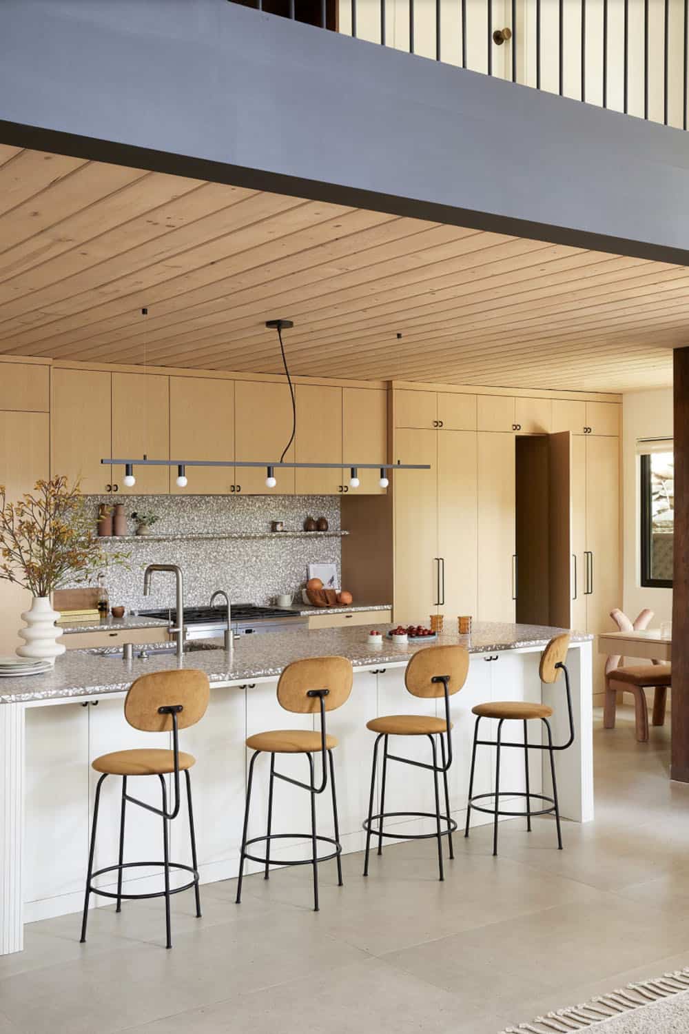 midcentury modern kitchen with a large island and bar stools