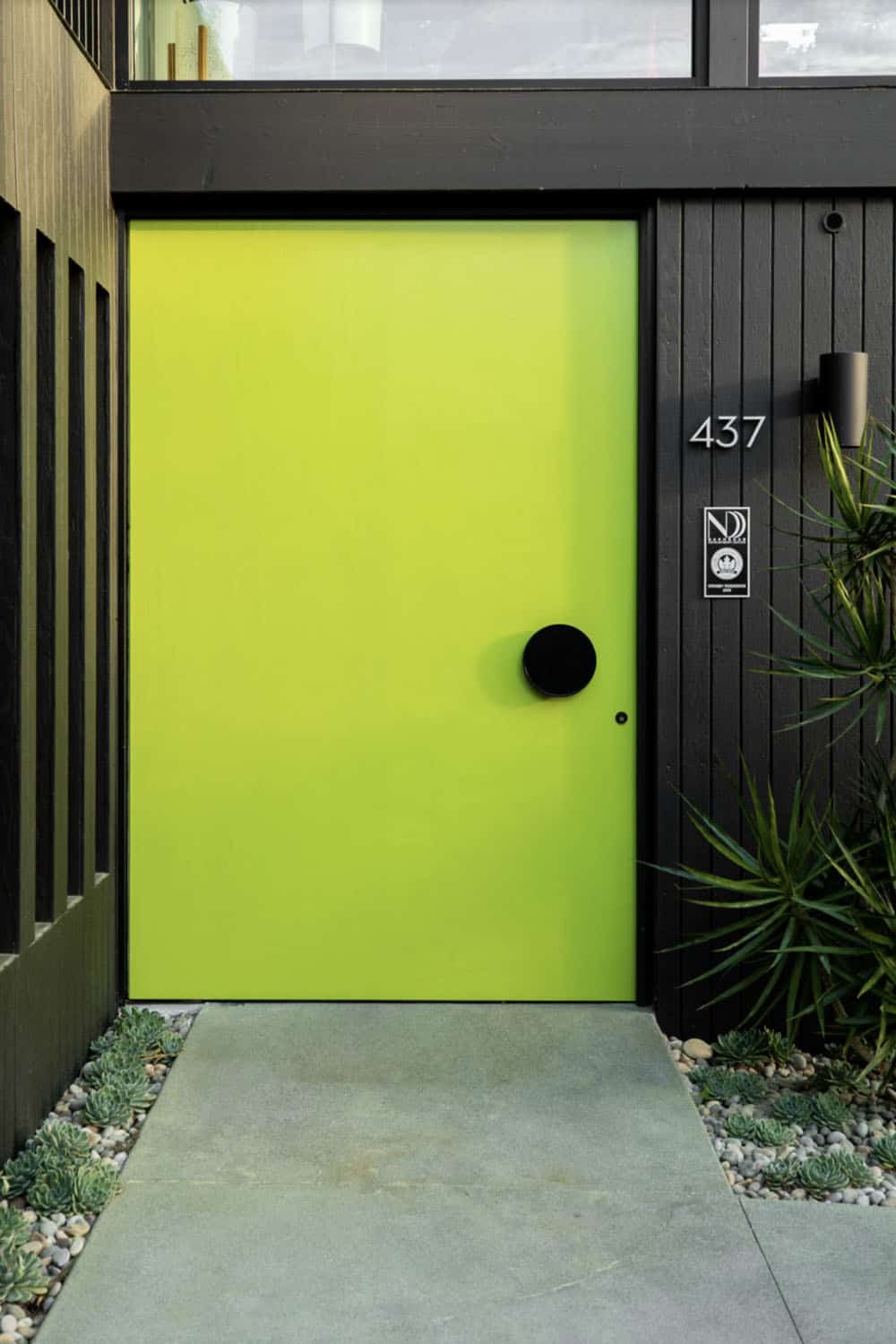 midcentury modern home exterior entry with a green door