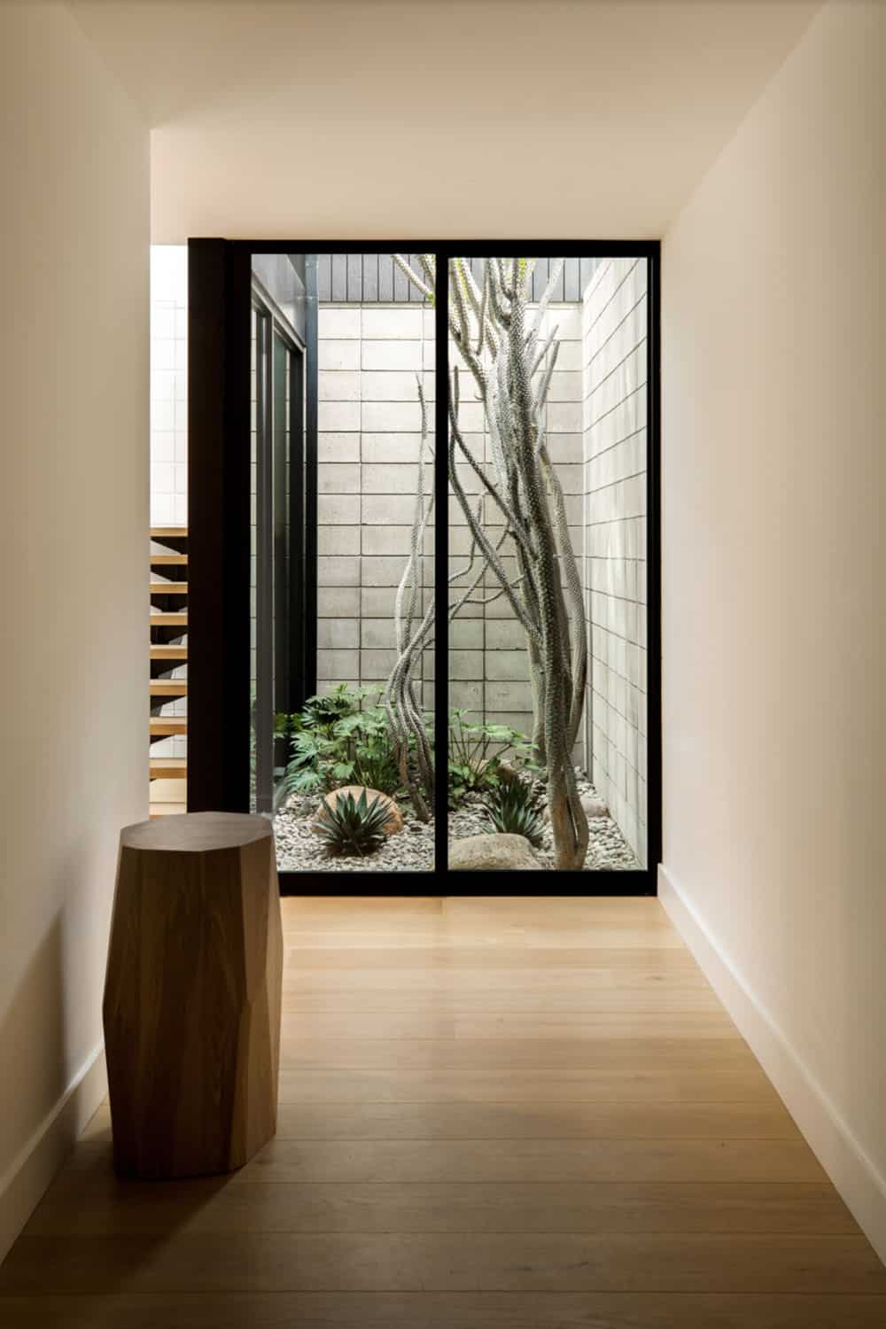midcentury modern hallway with a glass atrium